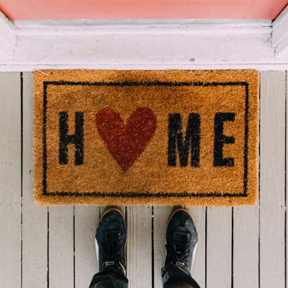 Brown rug with the word Home on it